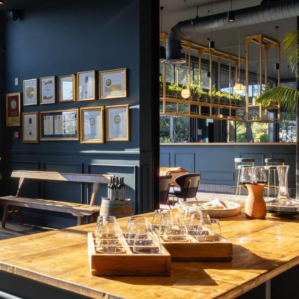 pask winery cellar door, wine tasting flights sit on the counter, restaurant in background